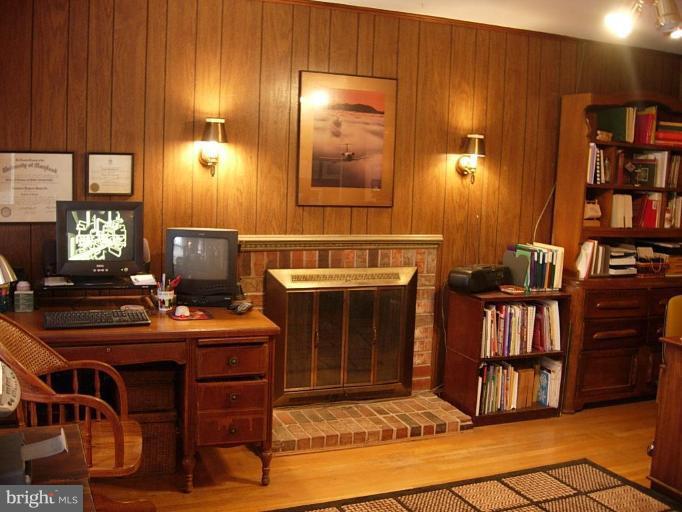 15212 Redgate Drive Silver Spring, MD 20905 - Photo 5 of 28 a view of a workspace with furniture and fireplace