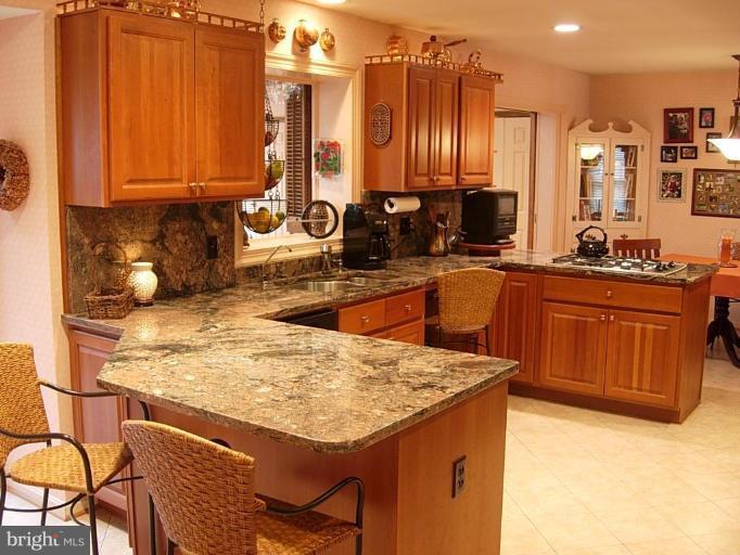 15212 Redgate Drive Silver Spring, MD 20905 - Photo 7 of 28 a kitchen with a sink a stove and cabinets