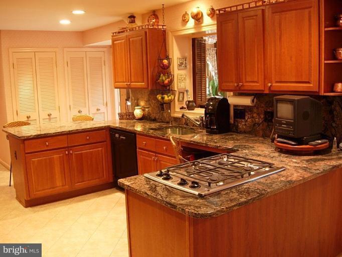 15212 Redgate Drive Silver Spring, MD 20905 - Photo 8 of 28 a kitchen with a sink a stove and cabinets