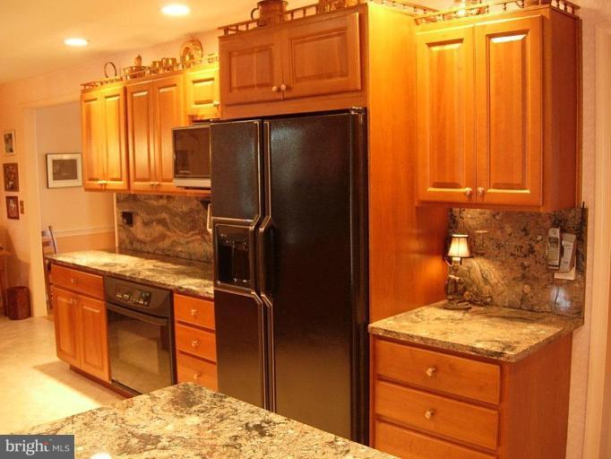 15212 Redgate Drive Silver Spring, MD 20905 - Photo 10 of 28 a kitchen with stainless steel appliances granite countertop a refrigerator and a stove