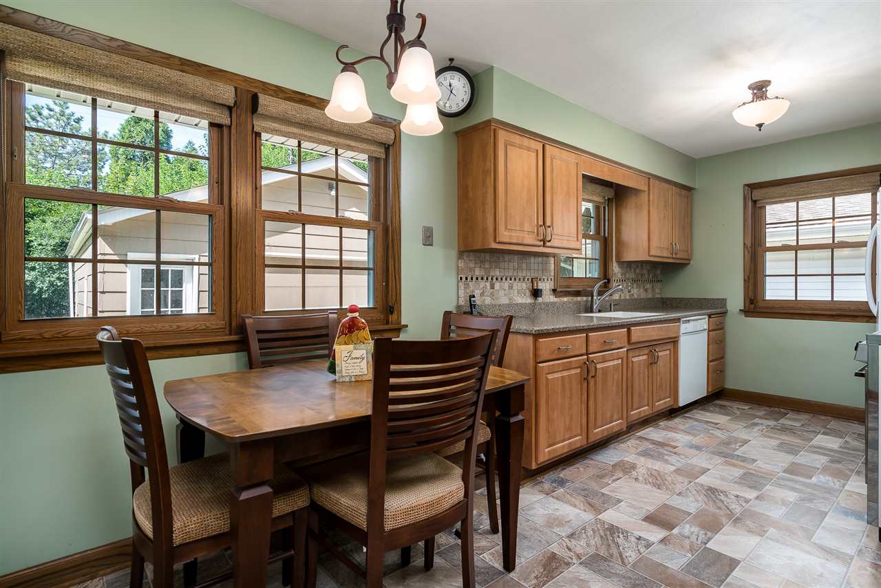 1104 Brookfield Road Rockford, IL 61107 - Photo 6 of 22 a kitchen with a stove a sink a dining table and chairs