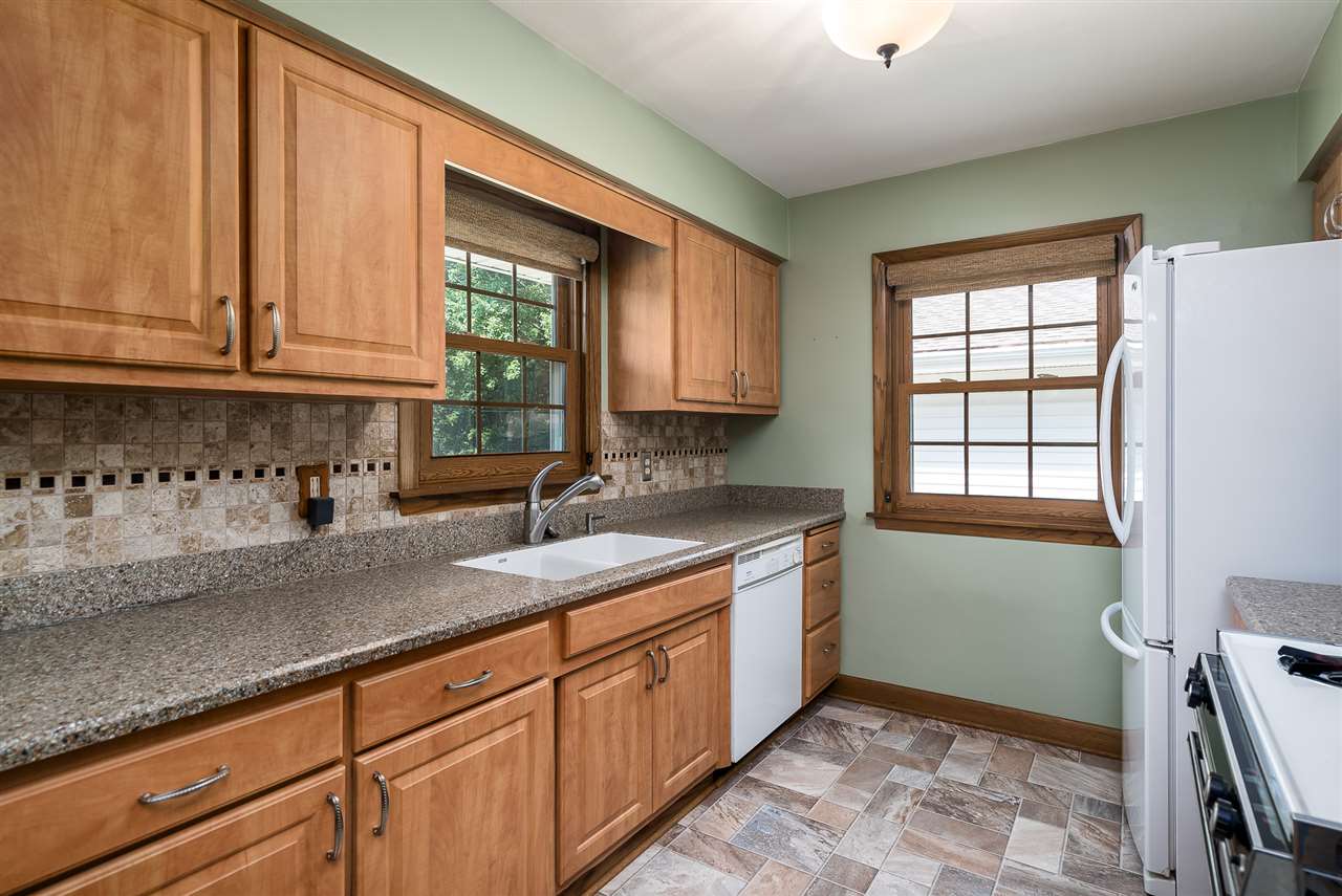 1104 Brookfield Road Rockford, IL 61107 - Photo 8 of 22 a kitchen with granite countertop a sink and a window
