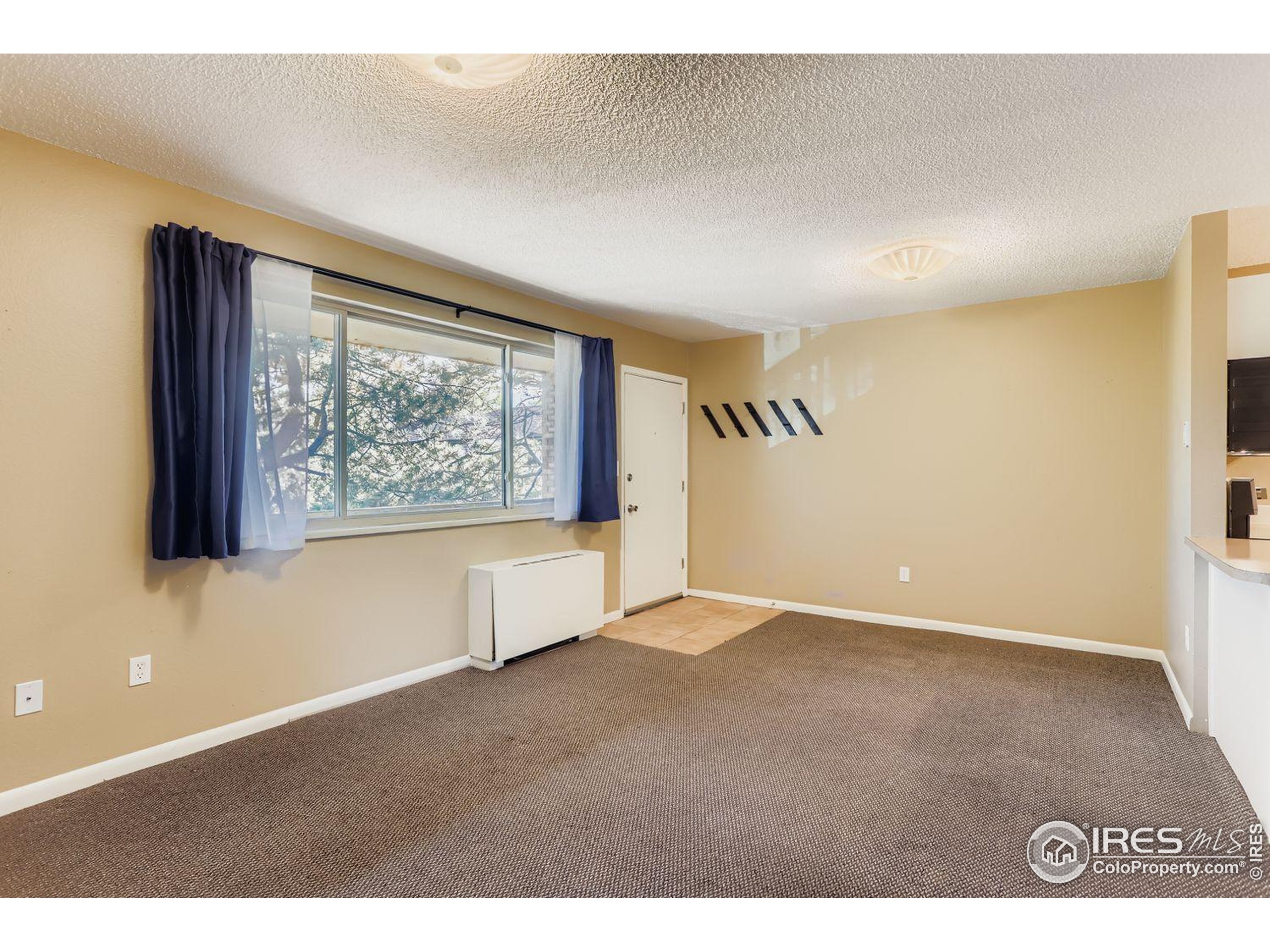 3000 Colorado Avenue, Unit B206 Boulder, CO 80303 - Photo 11 of 23 a view of an empty room with a window
