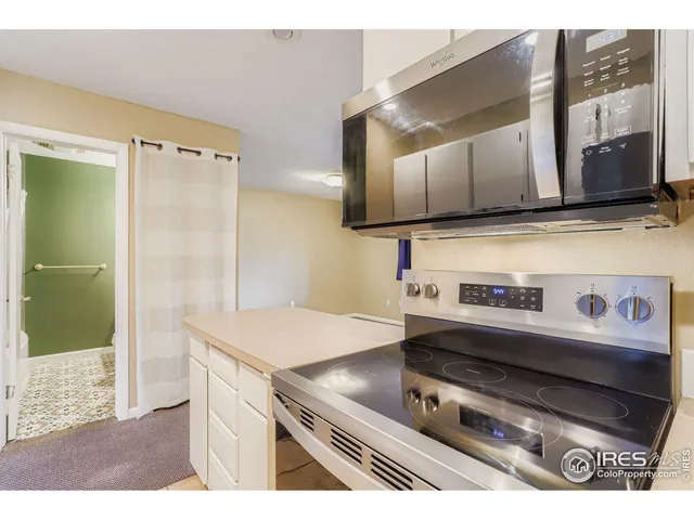 a kitchen with a stove and a refrigerator