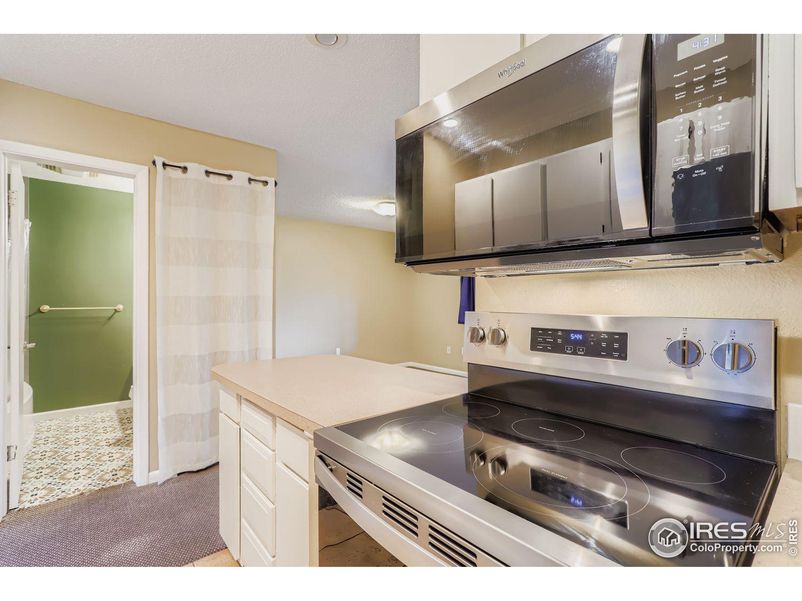 3000 Colorado Avenue, Unit B206 Boulder, CO 80303 - Photo 6 of 23 a kitchen with a stove and a refrigerator