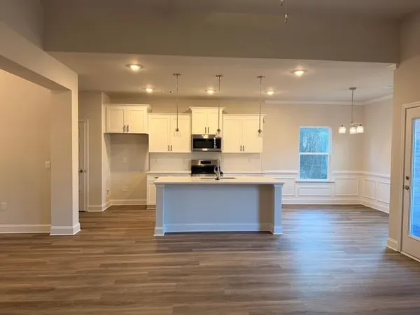 a view of a kitchen with a dishwasher cabinets and a wooden floor