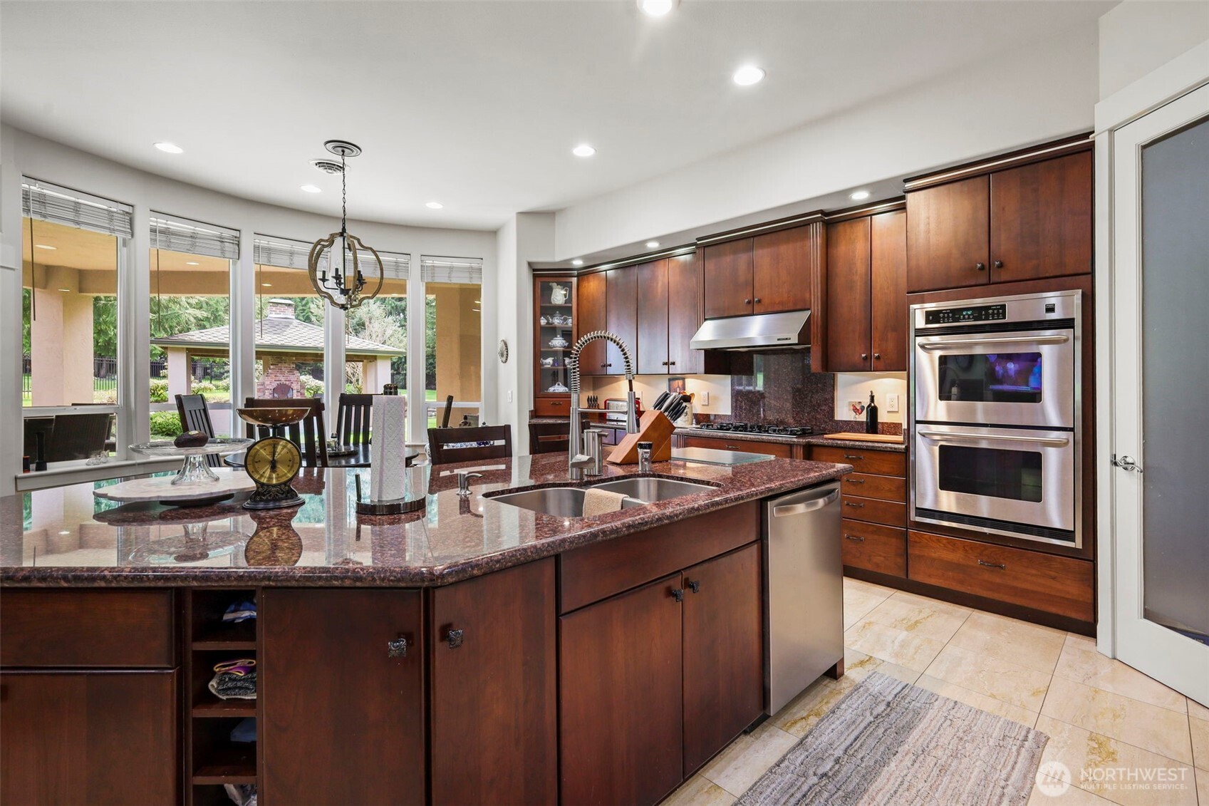 13612 231st Street East Graham, WA 98338 - Photo 4 of 40 a kitchen with stainless steel appliances granite countertop a sink refrigerator and cabinets