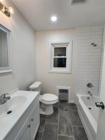 65 Halstead Street, Unit 1 Kearny, NJ 07032 - Photo 13 of 15 a bathroom with a bathtub shower sink mirror and toilet