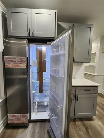 a kitchen with a refrigerator and a sink