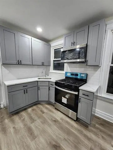 a kitchen with stainless steel appliances granite countertop a stove and a sink