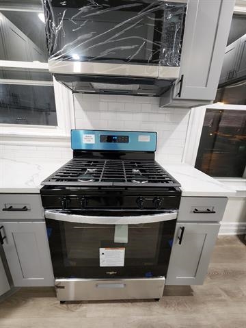 65 Halstead Street, Unit 1 Kearny, NJ 07032 - Photo 4 of 15 a stove top oven sitting inside of a kitchen