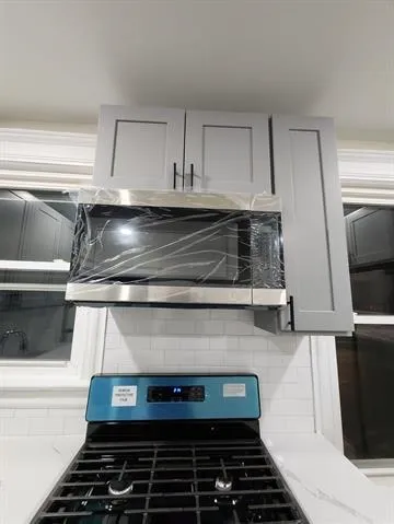 a stove top oven sitting inside of a kitchen