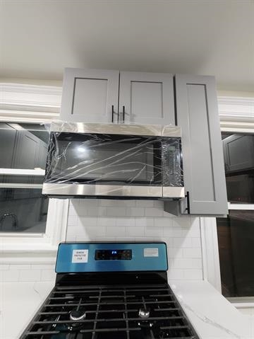 65 Halstead Street, Unit 1 Kearny, NJ 07032 - Photo 5 of 15 a stove top oven sitting inside of a kitchen