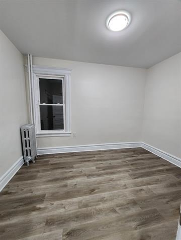 65 Halstead Street, Unit 1 Kearny, NJ 07032 - Photo 10 of 15 a view of an empty room with wooden floor and a window