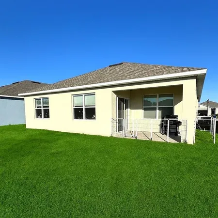 a view of a house with a backyard