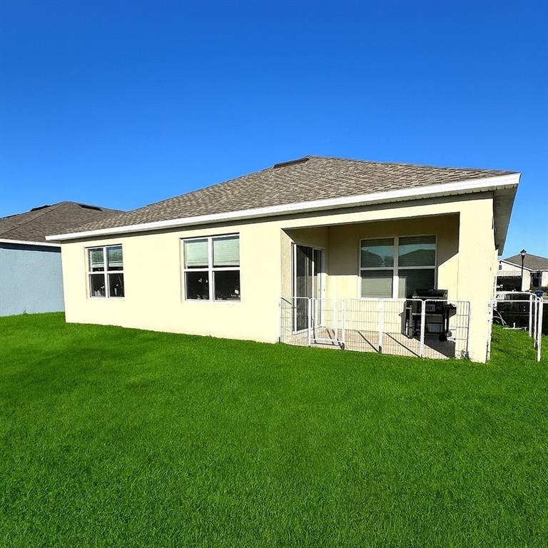 1122 Brimstone Circle Winter Haven, FL 33884 - Photo 16 of 17 a view of a house with a backyard
