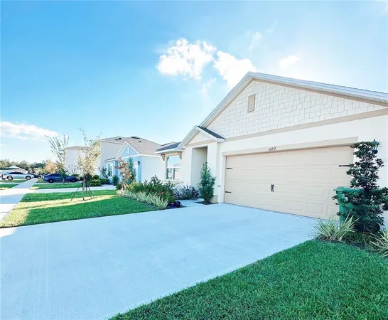 a view of a house with a yard and garage