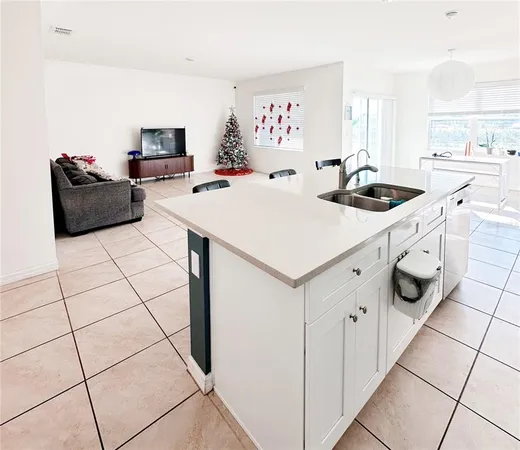 a kitchen with stainless steel appliances a sink a stove a microwave a counter top space and cabinets