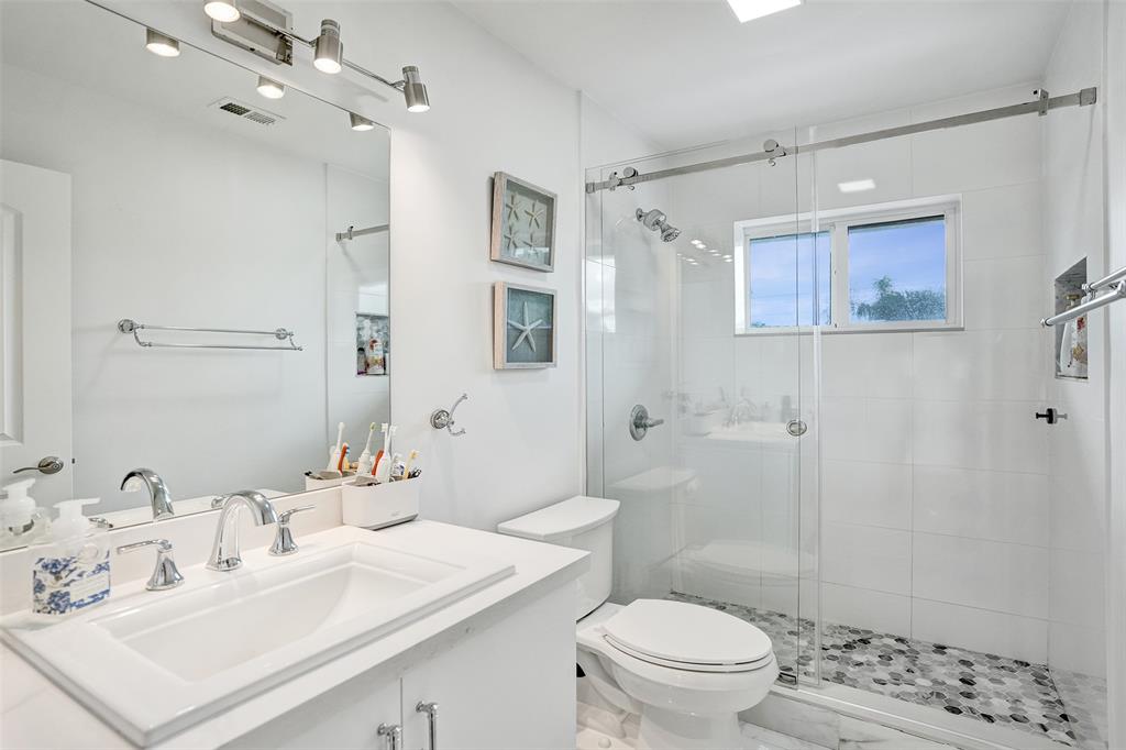 930 Greenbriar Avenue Davie, FL 33325 - Photo 13 of 28 a bathroom with a sink a toilet and shower