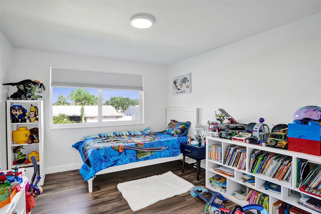930 Greenbriar Avenue Davie, FL 33325 - Photo 14 of 28 a living room with furniture and a book shelf