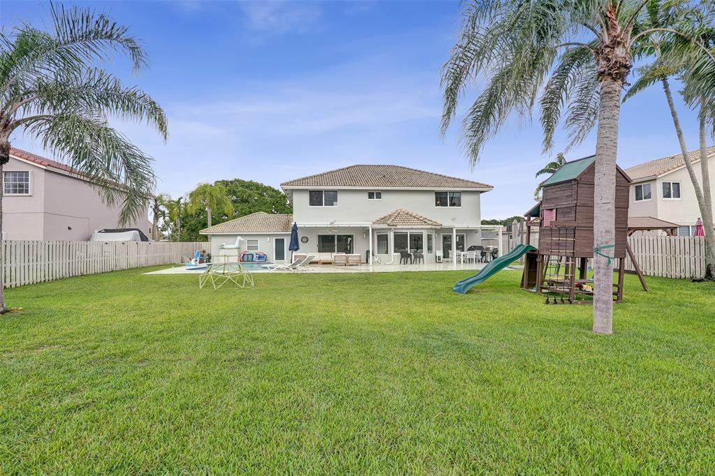930 Greenbriar Avenue Davie, FL 33325 - Photo 5 of 28 a view of a house with a big yard and a large tree