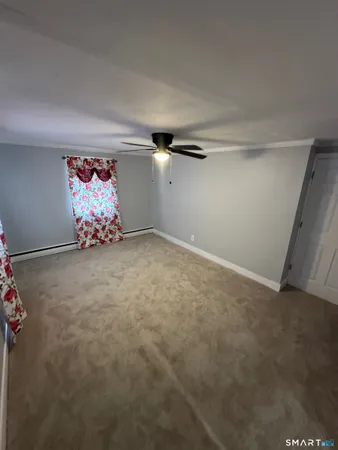 an empty room with painting on the wall