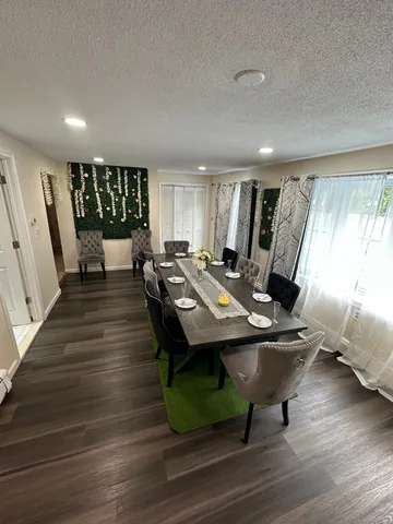 a view of a workspace with furniture window and wooden floor