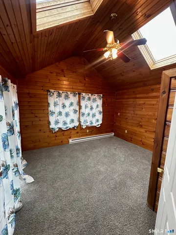 a view of a living room with furniture and stairs