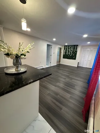 a large kitchen with stainless steel appliances granite countertop a refrigerator and a stove