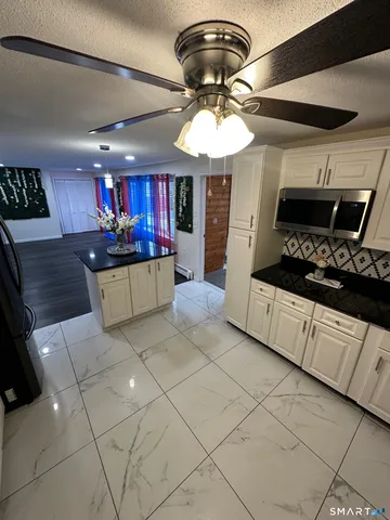 an empty room with wooden floor and fireplace