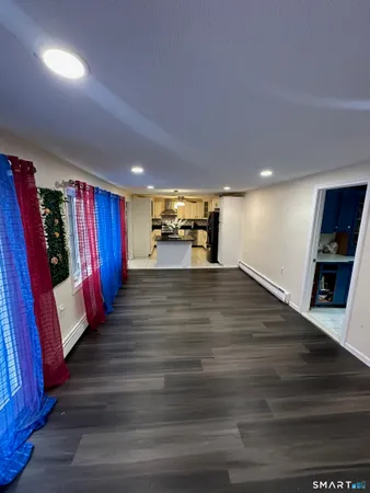 an empty room with wooden floor and fireplace