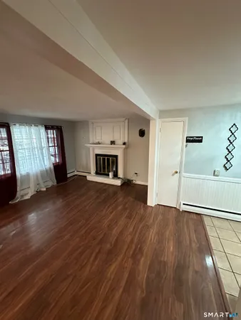 wooden floor in an empty room with a window