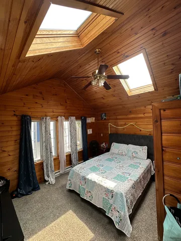 a bedroom with bed and window