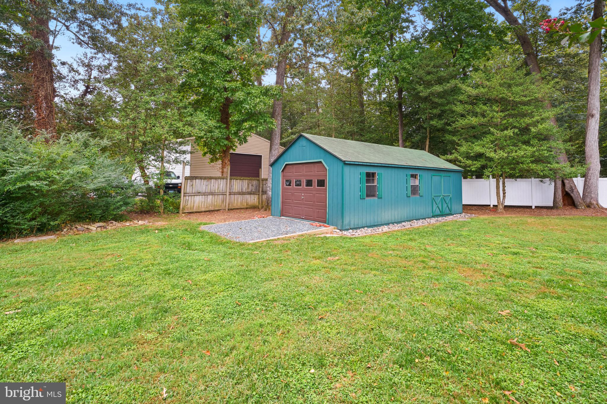 2718 Riva Road Annapolis, MD 21401 - Photo 22 of 25 Charming garden shed nestled in lush greenery.