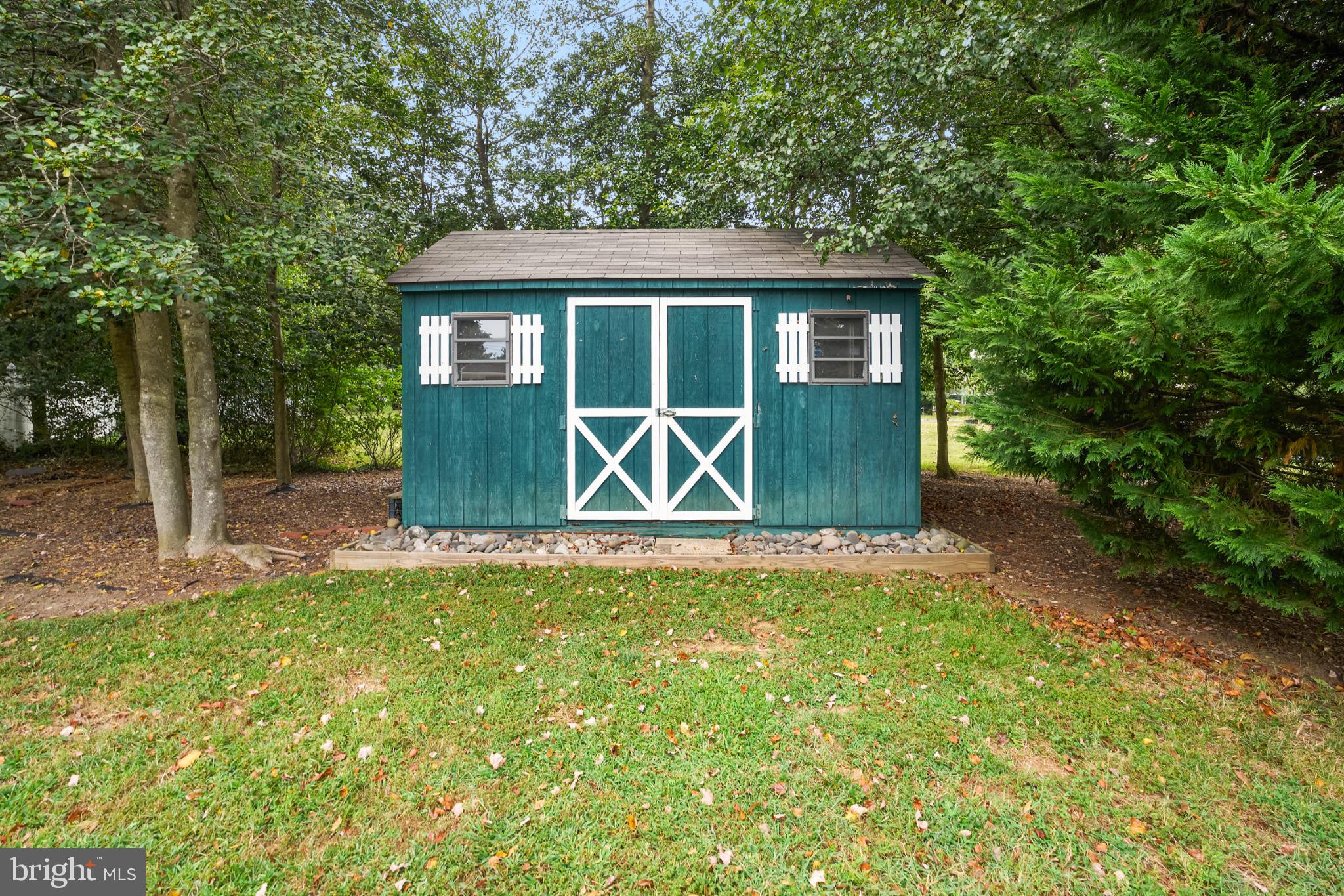 2718 Riva Road Annapolis, MD 21401 - Photo 24 of 25 Charming garden shed nestled in greenery.