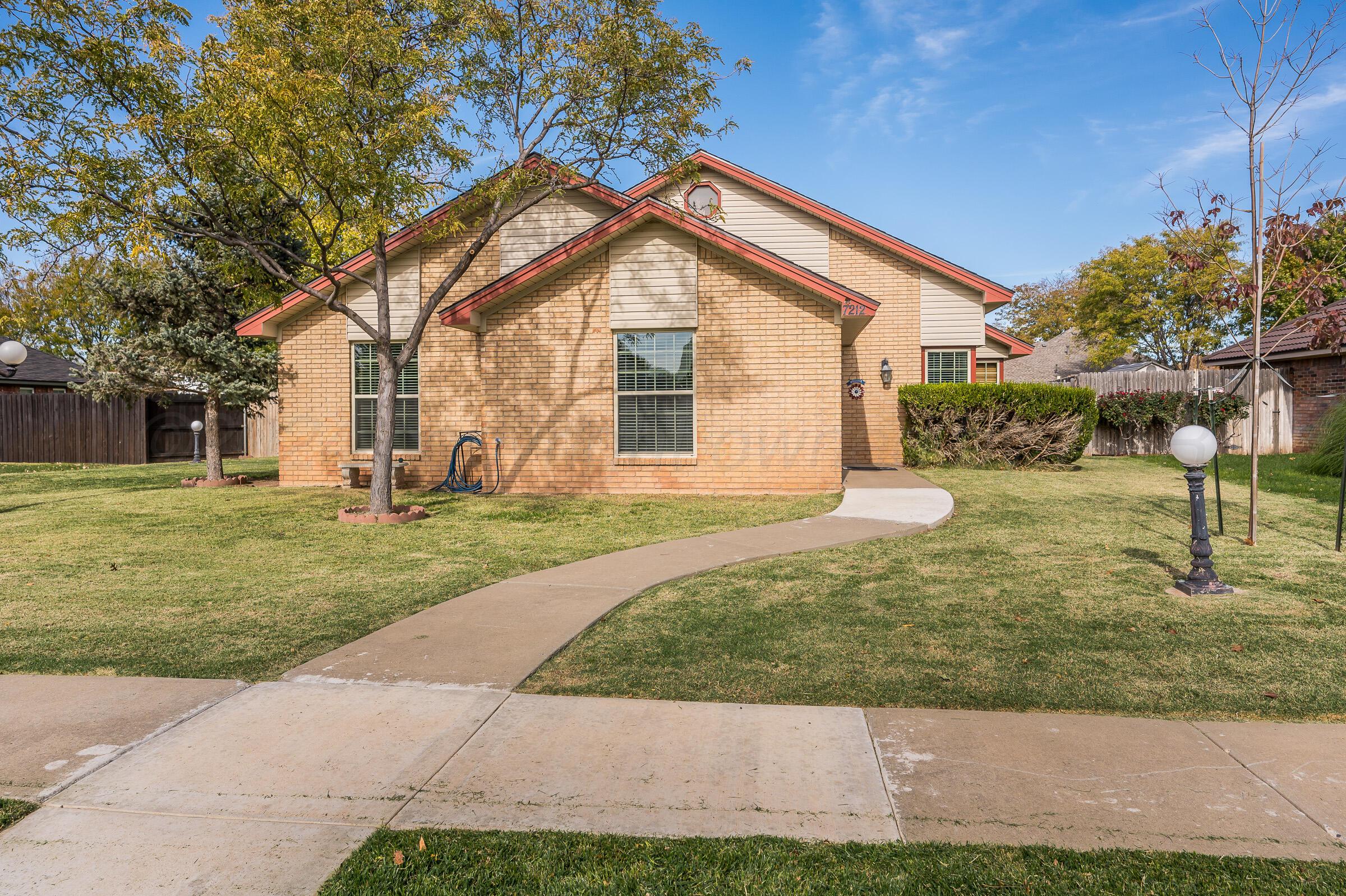7212 Dukes Place Amarillo, TX 79109 - Photo 2 of 21 a view of a house with backyard and trees