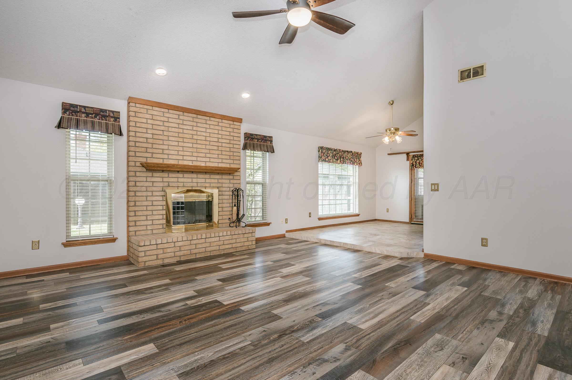 7212 Dukes Place Amarillo, TX 79109 - Photo 4 of 21 an empty room with wooden floor and windows