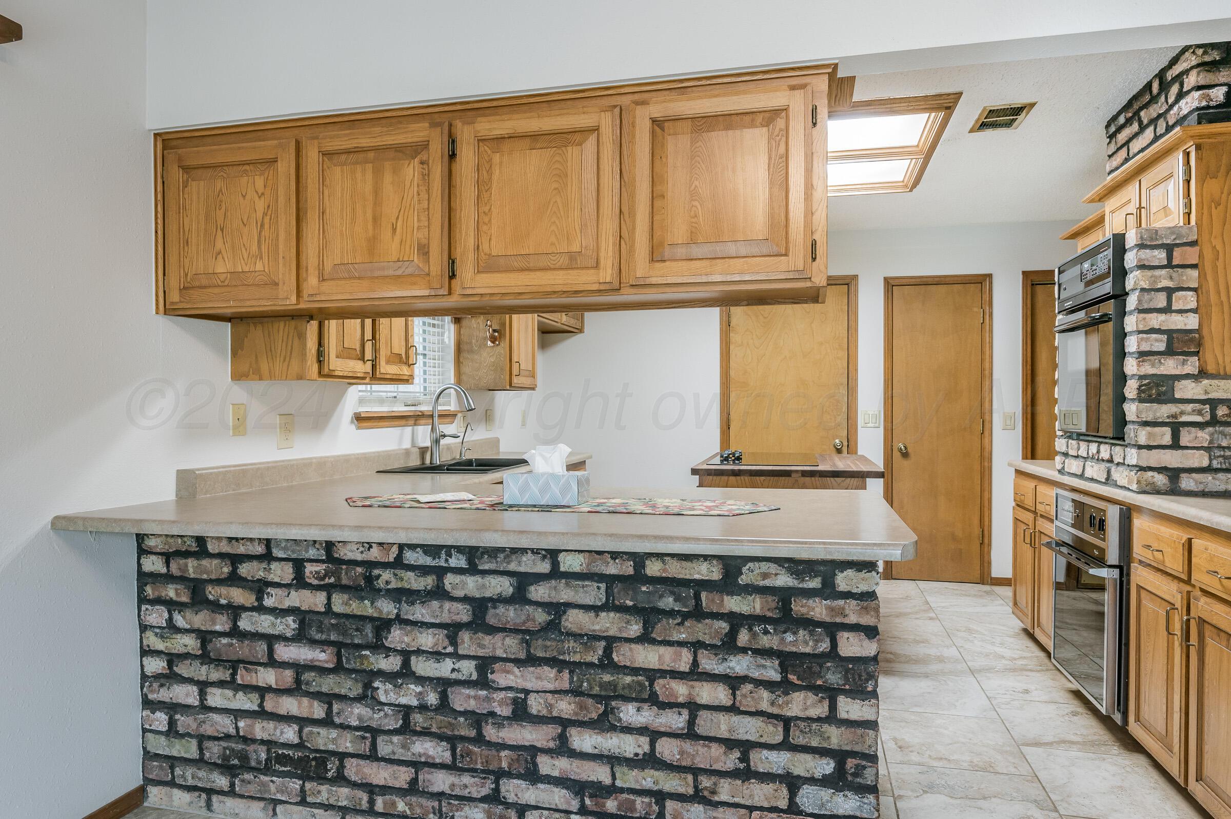7212 Dukes Place Amarillo, TX 79109 - Photo 7 of 21 a kitchen with a sink and cabinets