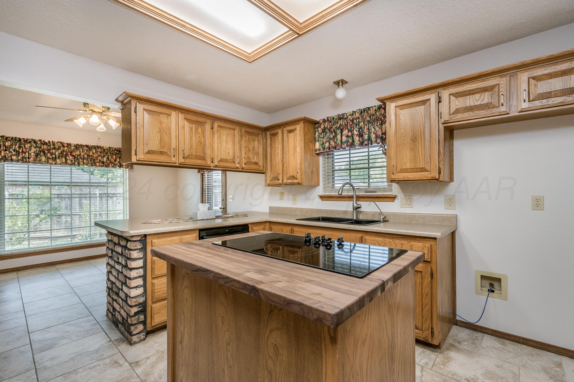 7212 Dukes Place Amarillo, TX 79109 - Photo 8 of 21 a kitchen that has a sink and a stove in it