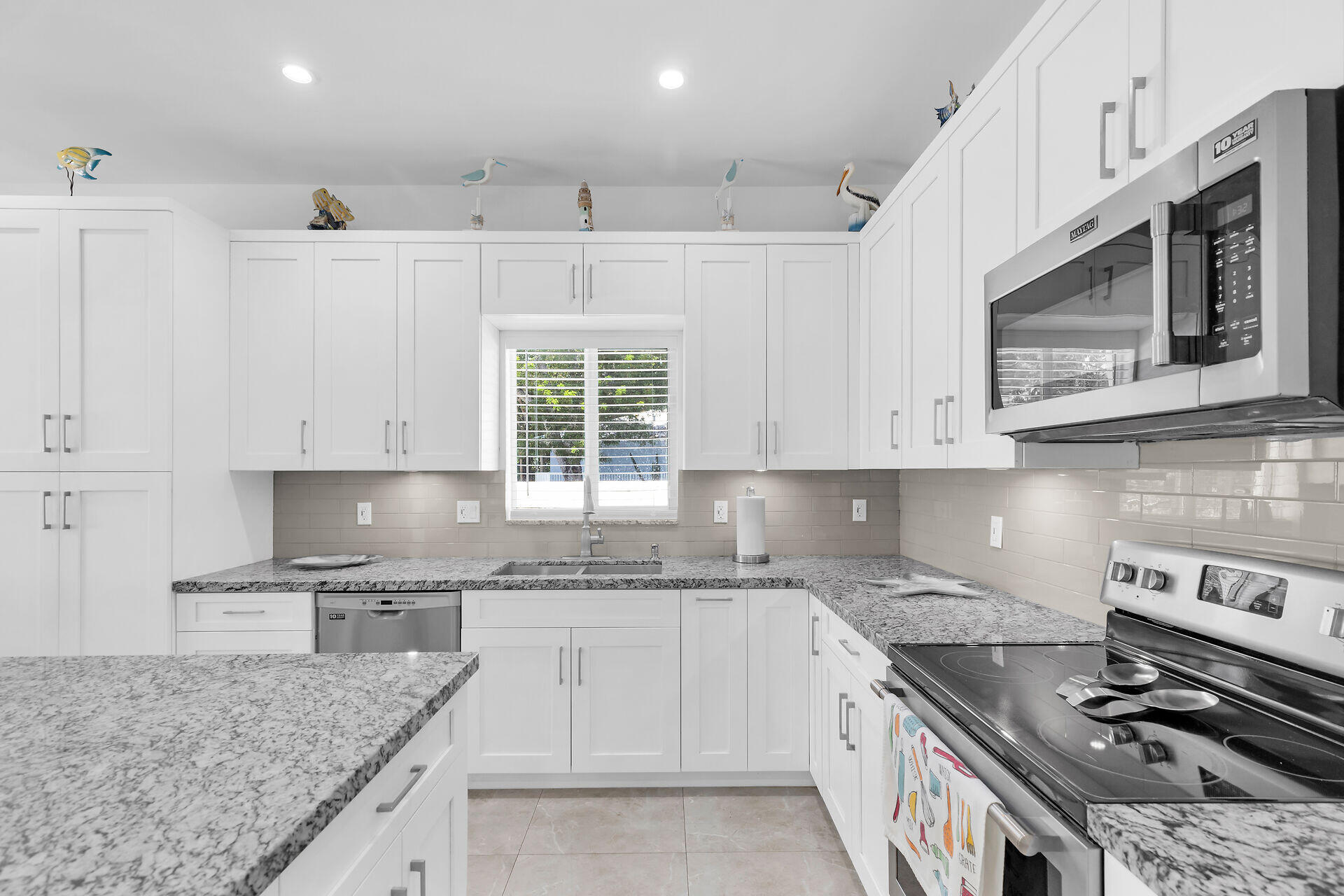 667 Colson Drive Key Largo, FL 33037 - Photo 13 of 48 a kitchen with stainless steel appliances granite countertop a stove sink and cabinets