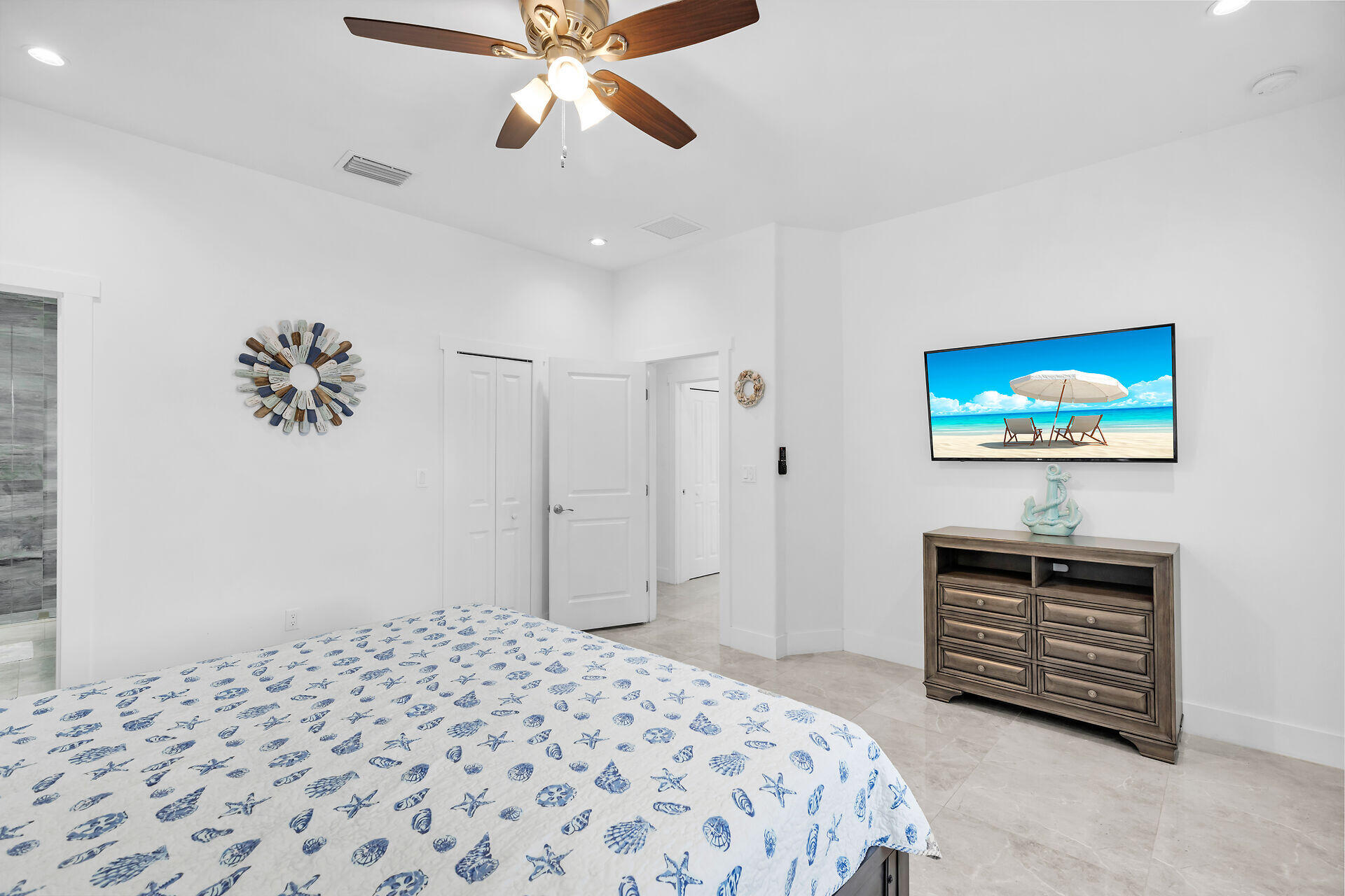 667 Colson Drive Key Largo, FL 33037 - Photo 16 of 48 a bedroom with a bed and a chandelier