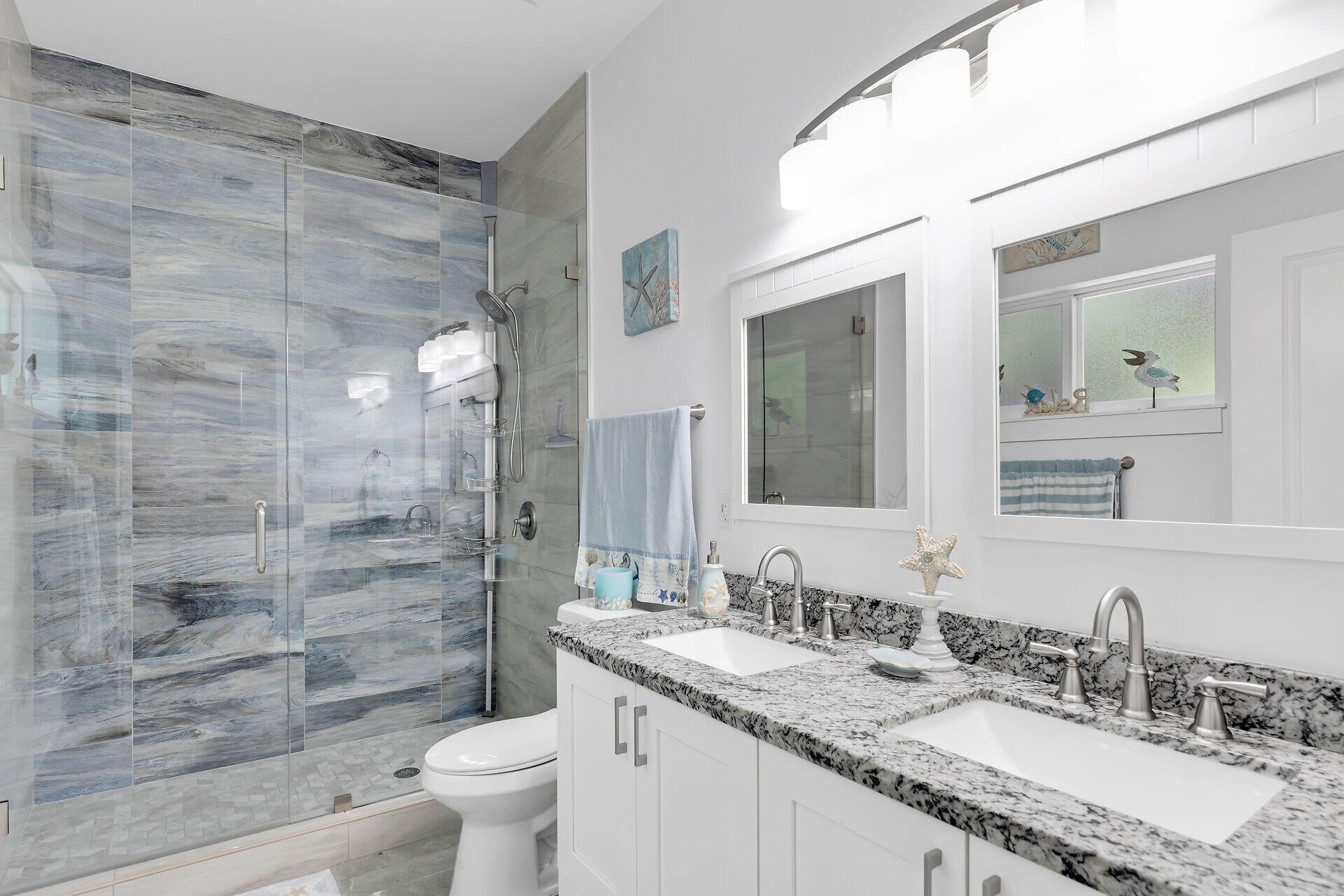 667 Colson Drive Key Largo, FL 33037 - Photo 17 of 48 a bathroom with a granite countertop sink a toilet a mirror and shower