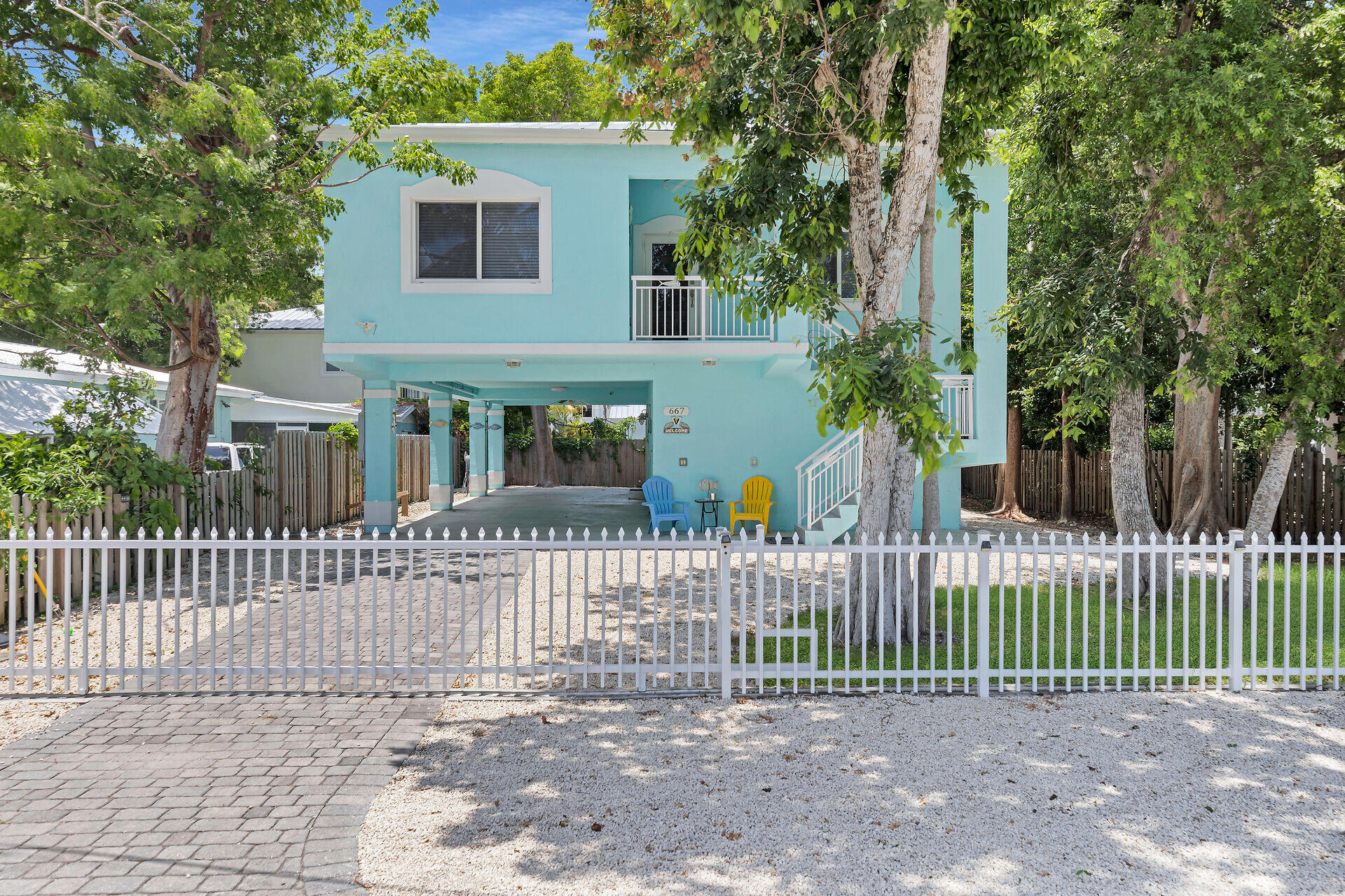 667 Colson Drive Key Largo, FL 33037 - Photo 2 of 48 a front view of a house with a small garden