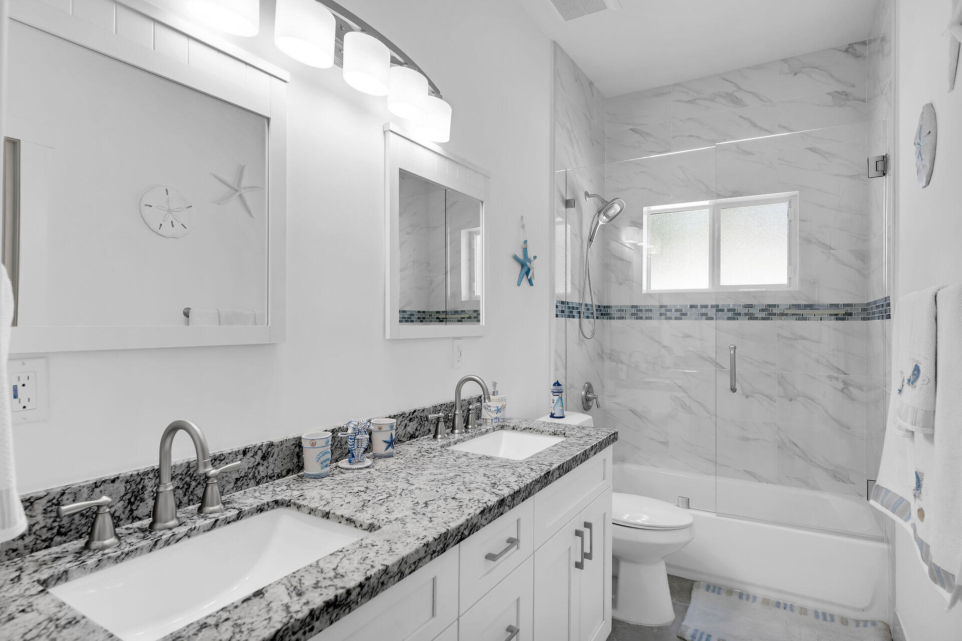 667 Colson Drive Key Largo, FL 33037 - Photo 22 of 48 a bathroom with a granite countertop sink a toilet and bathtub