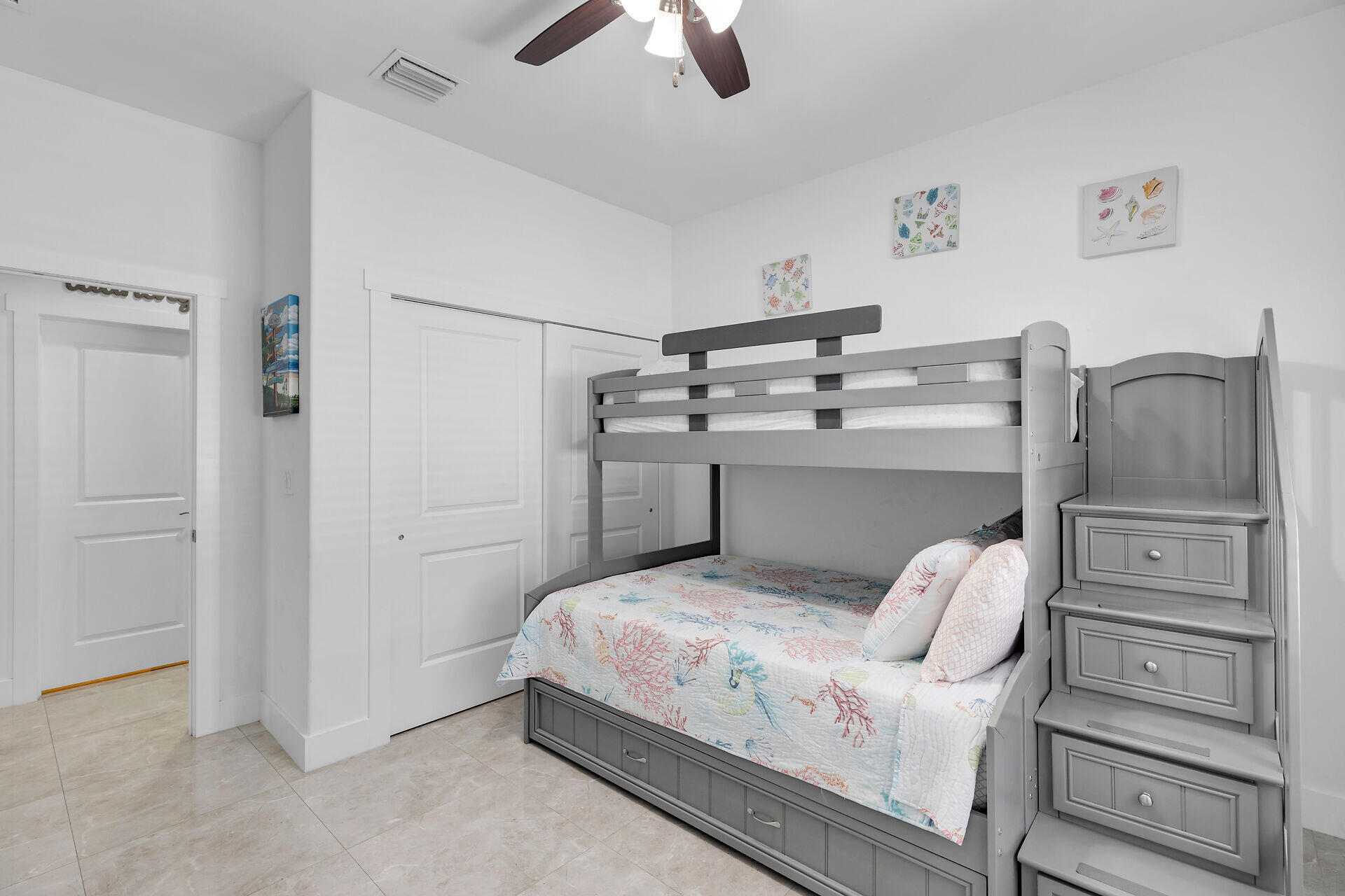 667 Colson Drive Key Largo, FL 33037 - Photo 24 of 48 a bedroom with a bed and ceiling fan