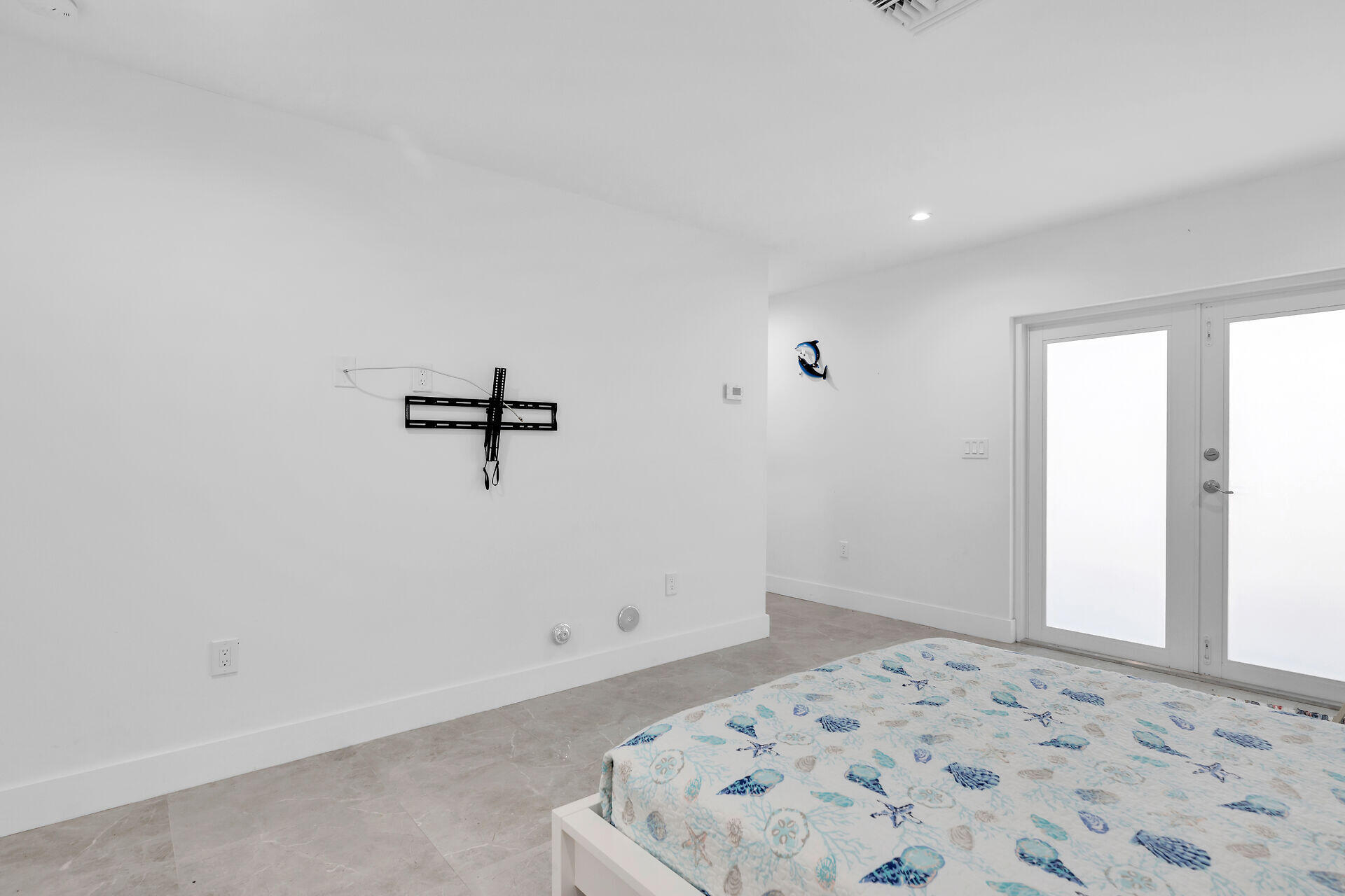 667 Colson Drive Key Largo, FL 33037 - Photo 30 of 48 a view of a bedroom with a bed and wooden floor