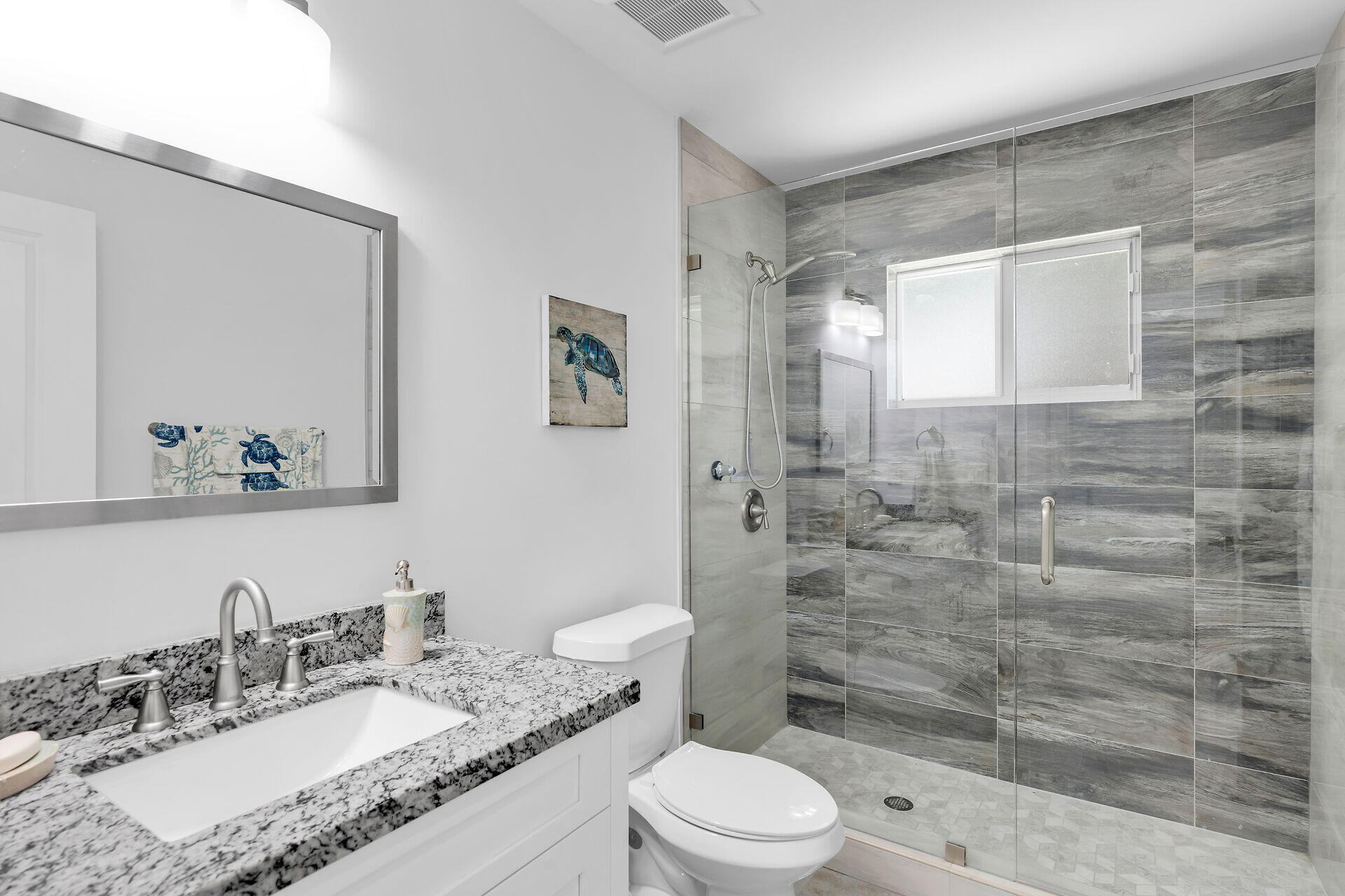 667 Colson Drive Key Largo, FL 33037 - Photo 31 of 48 a bathroom with a granite countertop sink toilet a mirror and shower