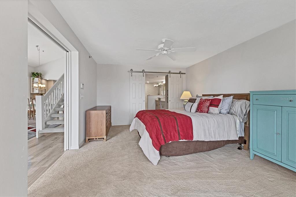 11000 Placida Road, Unit 1604 Placida, FL 33946 - Photo 18 of 42 a spacious bedroom with a bed and a chandelier