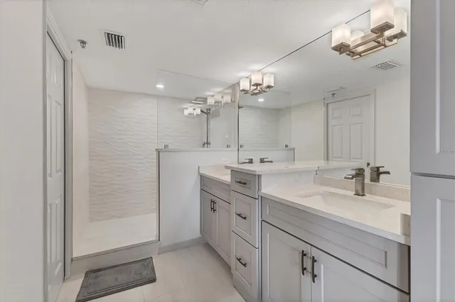 a bedroom with two beds and a chandelier