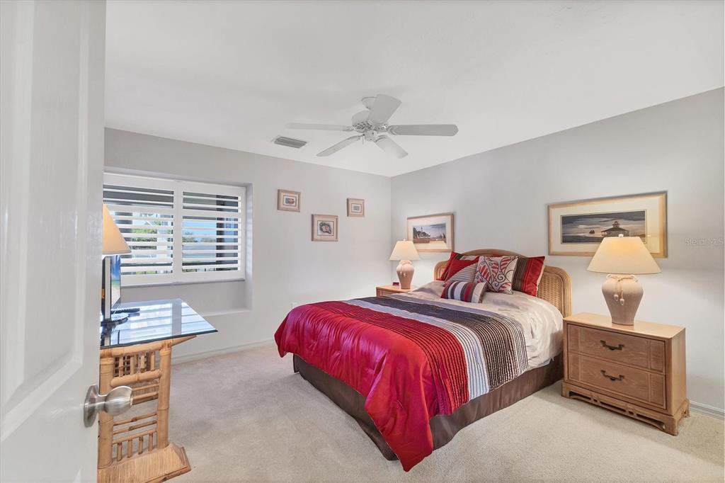 11000 Placida Road, Unit 1604 Placida, FL 33946 - Photo 21 of 42 a bedroom with a bed and a chandelier